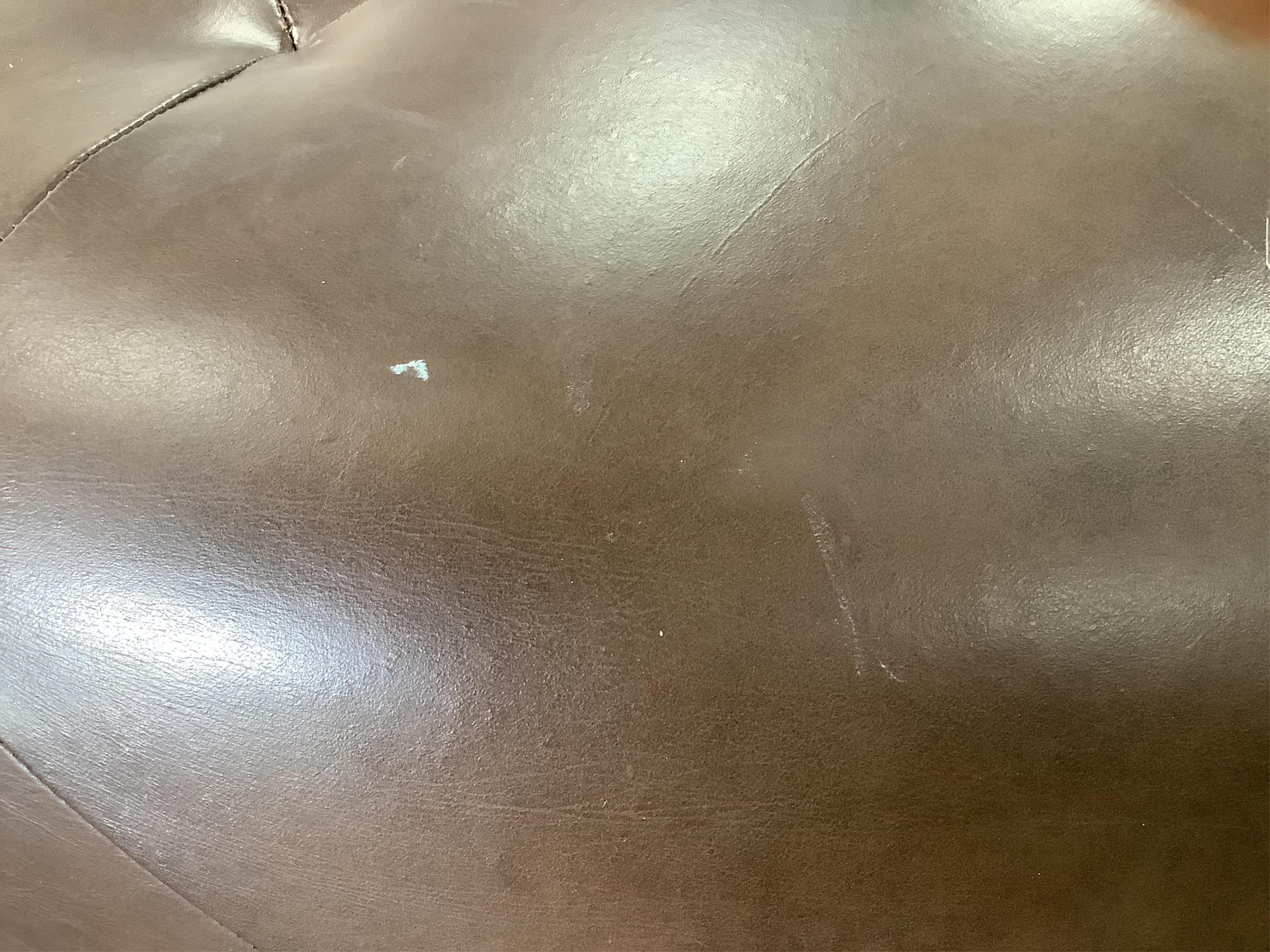 A circular brown leather footstool, diameter 100cm, height 36cm. Condition - fair